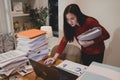 Asian businesswoman working hard late hours with a lot of document at home. Busy and exhausted of work overtime Royalty Free Stock Photo