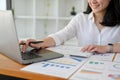 Asian businesswoman working at her office desk, using laptop and calculator. cropped Royalty Free Stock Photo