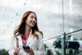 Asian businesswoman working with mobile phone standing against street front Royalty Free Stock Photo