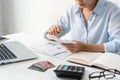 Asian businesswoman working at office. Female checking account balance and calculating credit card expenses. Family financial