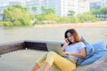 Asian businesswoman working online at the beach. Freelancer using technology for work everywhere. Woman talking with customer Royalty Free Stock Photo