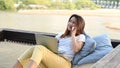 Asian businesswoman working online at the beach. Freelancer using technology for work everywhere. Woman talking with customer Royalty Free Stock Photo