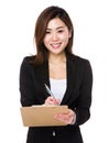 Asian businesswoman write on clipboard