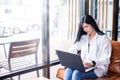 Asian businesswomen are using notebook computers and wear headphones for online meetings and working from home Royalty Free Stock Photo