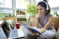 Asian businesswomen is using notebook computers and wear headphones for online meetings and working from home Royalty Free Stock Photo