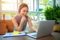 Asian businesswomen is using notebook computers and wear headphones for online meetings and working from home Royalty Free Stock Photo