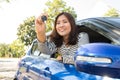 Asian car driver woman smiling showing new car keys Royalty Free Stock Photo