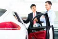 Asian Car Salesman selling auto Royalty Free Stock Photo