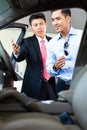 Asian Car Salesman selling auto to customer Royalty Free Stock Photo