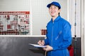 Asian car technician smiling in garage service Royalty Free Stock Photo