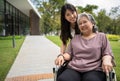 Asian careful caregiver or nurse taking care of the patient in a wheelchair. Concept of happy retirement with care from a Royalty Free Stock Photo