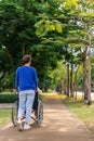 Asian careful caregiver or nurse taking care of the patient in a wheelchair. Concept of happy retirement with care from a Royalty Free Stock Photo