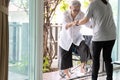 Asian caregiver help care to senior grandmother walk,woman holding hands of the old elderly for support,walking up from a Royalty Free Stock Photo