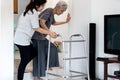Asian Caregiver Helping To Senior Woman Walking For Safety In Balance During The Steps Up And Down The Stairs Or Be Careful