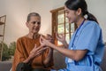 Asian caregiver nurse give consult to Caucasian senior woman 60s patient. Attractive care pharmacist hold medicine pills Royalty Free Stock Photo