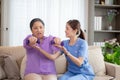 Asian caregiver woman or nurse training senior woman lifting dumbbell for arm exercise while therapy and rehabilitation.