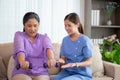 Asian caregiver woman or nurse training senior woman lifting dumbbell for arm exercise while therapy and rehabilitation. Royalty Free Stock Photo