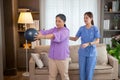 Asian caregiver woman or nurse training senior woman lifting sport ball with hands for exercise while physical therapy.