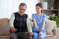 Asian caregiver woman or nurse training senior man lifting dumbbell for arm exercise while therapy and rehabilitation. Royalty Free Stock Photo