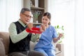 Asian caregiver woman or nurse training senior man stretch arm for exercise while therapy and rehabilitation. Royalty Free Stock Photo