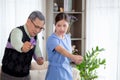 Asian caregiver woman or nurse training senior man stretch arm for exercise while therapy and rehabilitation. Royalty Free Stock Photo