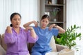 Asian caregiver woman or nurse training senior woman warmup for exercise while physical therapy.