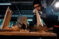 Asian carpenter craftsman check lines of wood while making pool cue or snooker cues with a manual hand wood planer in a carpentry