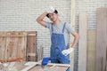 Asian carpenter getting tired after work