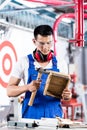 Asian Carpenter in wood workshop working