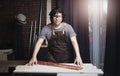 Asian Carpenter Working in Woodworking Workshop. Smile at Camera Royalty Free Stock Photo