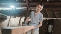 Asian carpenters work on electric wooden dowels and observe rough wood surfaces