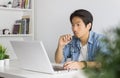 Asian Casual Businessman or Freelancer Working with Laptop in Home Office Royalty Free Stock Photo