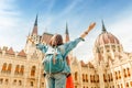 Asian casual woman student enjoying great view of the Parliament building in Budapest city, travel in Europe concept