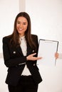 Asian caucasian busines woman writing on a clipboard Royalty Free Stock Photo