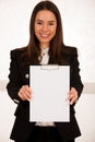 Asian caucasian busines woman writing on a clipboard Royalty Free Stock Photo