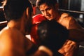 Asian and Caucasian Muay Thai boxers exchanging punch. Impetus