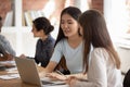 Asian and caucasian students girls prepare schoolwork common task together