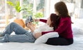 Asian cheerful female LGBTQ lesbian lover laying lying down on couple partner pillow lap holding looking at health test film xray Royalty Free Stock Photo