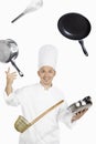 Asian chef juggling kitchen utensil. Conceptual image