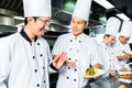 Asian Chef in restaurant kitchen cooking Royalty Free Stock Photo