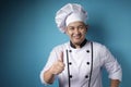 Asian Chef Smiling at Camera and Shows Thumbs Up Gesture