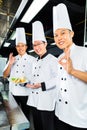 Asian Chefs in hotel restaurant kitchen Royalty Free Stock Photo