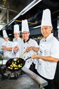 Asian Chefs in restaurant kitchen Royalty Free Stock Photo