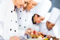 Asian Chefs in restaurant kitchen cooking Royalty Free Stock Photo
