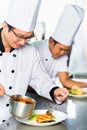 Asian Chefs in restaurant kitchen cooking Royalty Free Stock Photo