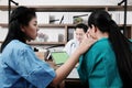 Asian chief physician man is meeting with surgeon doctor women wear blue and green surgical gown is serious. Medical team are Royalty Free Stock Photo