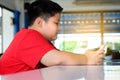 Asian child Boy are addictive playing tablet and mobile phones