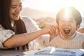 Asian child boy having fun with her mother outdoors in summer day - Focus on kid face Royalty Free Stock Photo