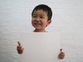 Asian child boy holding white blank board with happy smiling face. Royalty Free Stock Photo