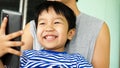 Asian child boy smiling with happy face, hand holding smartphone Royalty Free Stock Photo